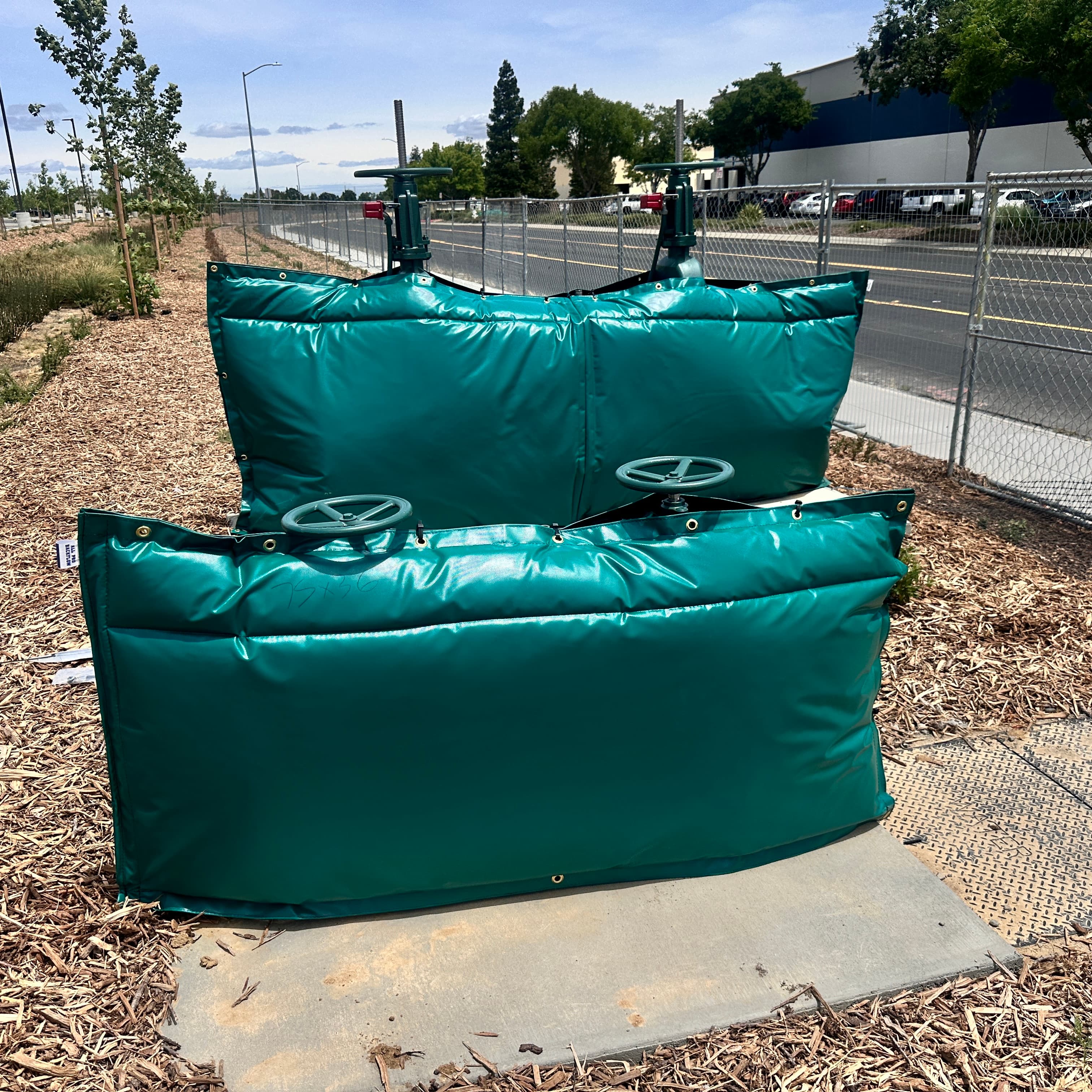 Green Sub Zero Covers freeze bags installed on backflow preventer assemblies